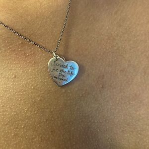 Heart necklace with the words” she decided to live the life she imagined”